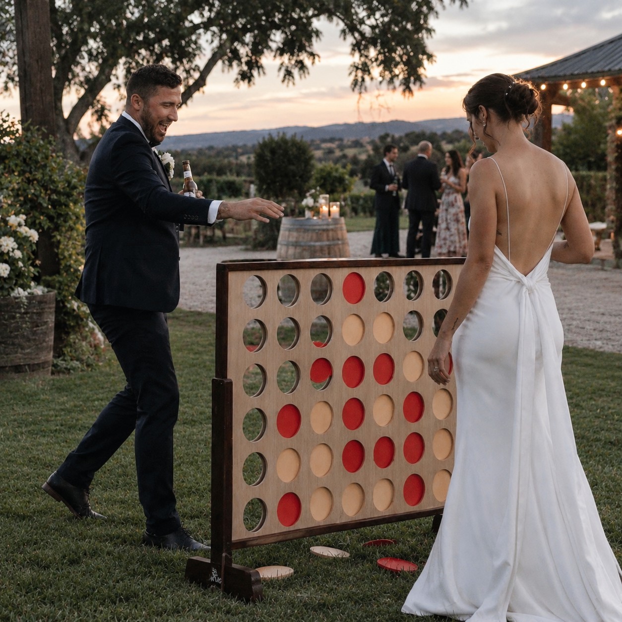 Giant Connect 4 being played at an outdoor wedding